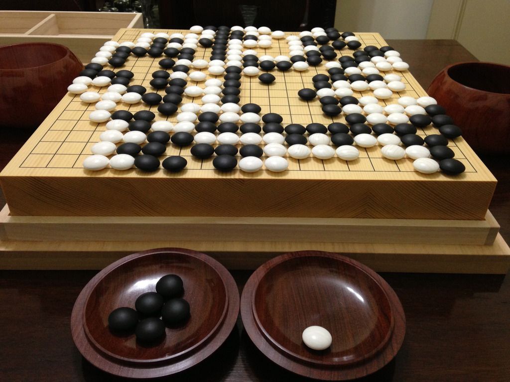 the first artificial intelligence to receive the highest honor in the game of go